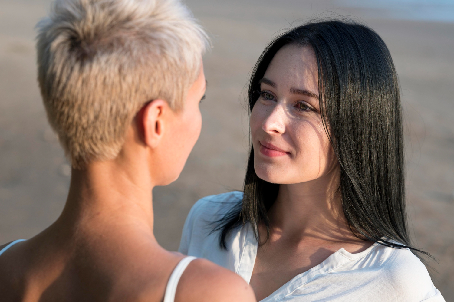 Two women sharing a thoughtful conversation outdoors